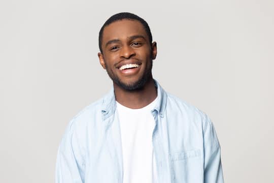Adult man smiling showing healthy straight teeth and natural smile alignment