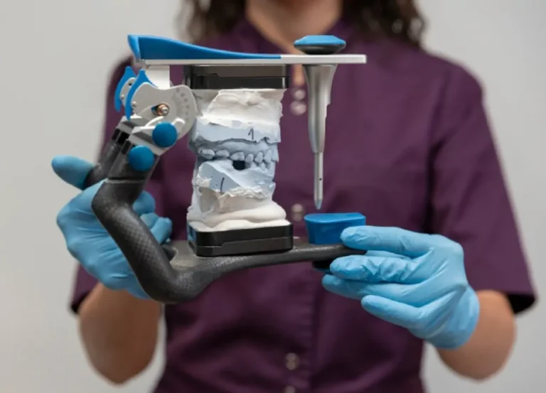 Dental professional holding jaw model used for orthognathic jaw surgery planning